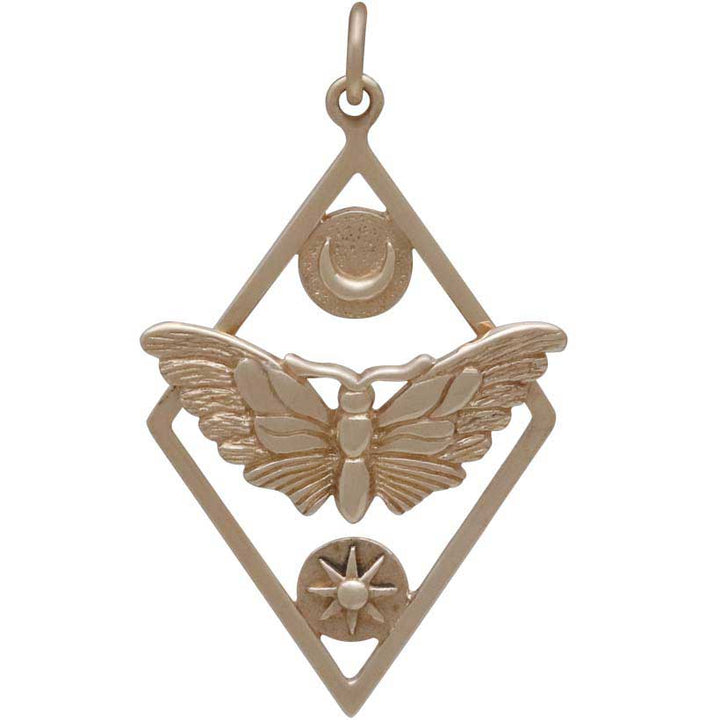 The Bronze Geometric Moth Charm with Sun and Moon, crafted by Nina Designs, features a moth with outstretched wings at its center symbolizing passionate pursuits. Above the moth is a crescent moon representing intuition, while below it rests a small eight-pointed star within a circle. These celestial shapes are enclosed in a diamond-shaped frame, complete with a loop for hanging at the top.