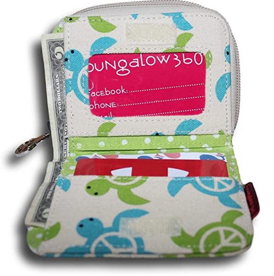 A small, opened cotton canvas Bill Fold Wallet Sea Turtle from Bungalow 360, showcasing a fabric exterior and interior adorned with a green and blue turtle pattern. It contains cash, a red card in a transparent slot, and a partially visible pink contact card printed with "Bungalow 360" and placeholder lines for contact information.