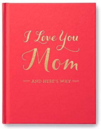 A red book with gold embossed text on the cover that reads "I Love You Mom" followed by "And Here's Why," from the Compendium brand, is upright and positioned against a white background. This personal keepsake serves as a perfect gift of gratitude.