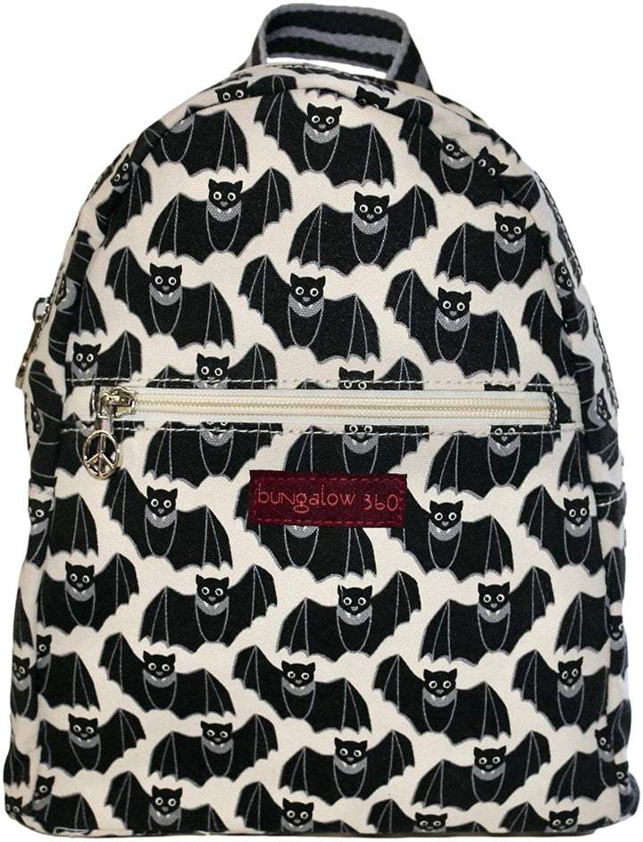 Introducing the Backpack Bat by Bungalow 360, crafted entirely from cotton canvas and adorned with a striking black bat pattern set against a white backdrop. The front zipper pocket is accentuated with a distinctive small peace sign pull, complemented by a red label that proudly displays "Bungalow 360." The design stands out with unique black and white striped detailing on both the zipper pulls and straps.