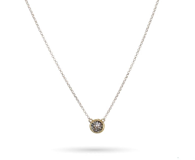 The Kristal Dome Necklace 18in by Waxing Poetic features an intricate design with a slender gold chain and a central circular pendant adorned with a shimmering gemstone. Displayed against a simple white background, this stunning piece enhances any outfit with its sophisticated charm.