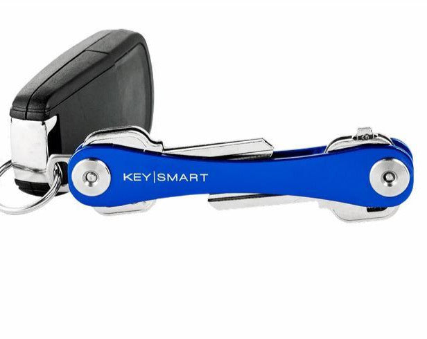 The KeySmart Key Holder Blue, from the brand KeySmart, attached to a car key fob keeps your keys perfectly organized. Its sleek design, with visible metal components at the ends, eliminates key jingle for a quieter carry experience.