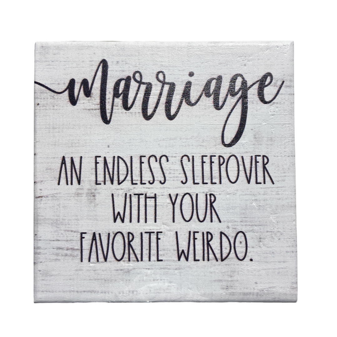 The SincereSurroundings "Marriage Endless" is a handcrafted decorative sign that features the text: "Marriage: An endless sleepover with your favorite weirdo" in black script on a white wooden background, making it perfect for easy display.