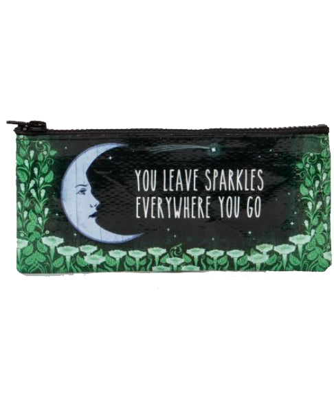 The "You Leave Sparkles Pencil Case" by Blue Q is a rectangular zippered pouch made from recycled materials. It features an illustration of a crescent moon and green foliage, along with the inspirational text, "You leave sparkles everywhere you go." It's perfect for storing your glitter gel pens.