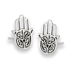 The "Hand Of Fatima Silver Stud" earrings by Welman are crafted from sterling silver and feature intricate cut-out swirl designs in the shape of the Hamsa hand. These mask-friendly earrings offer a comfortable fit and are elegantly displayed against a white background.