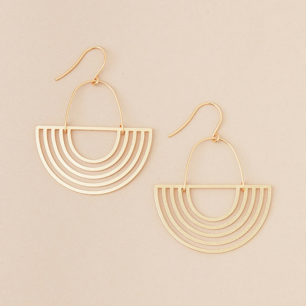 Introducing the Solar Rays Gold earrings from Scout Jewelry's Refined Earring Collection. Set against a beige background, these hypoallergenic beauties feature a semicircular design with multiple concentric arcs connected to a hook clasp, crafted for elegance and comfort.