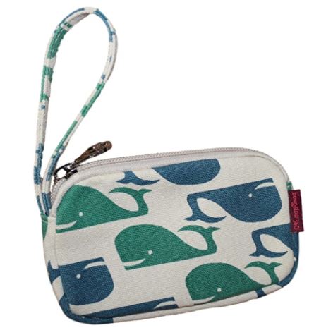 The Tiny Wristlet Whale by Bungalow 360 is a small, vegan clutch made from natural cotton canvas, featuring a pattern of blue and green whales on a white background. It includes a wrist strap, silver zipper, and a small red tag on the side.