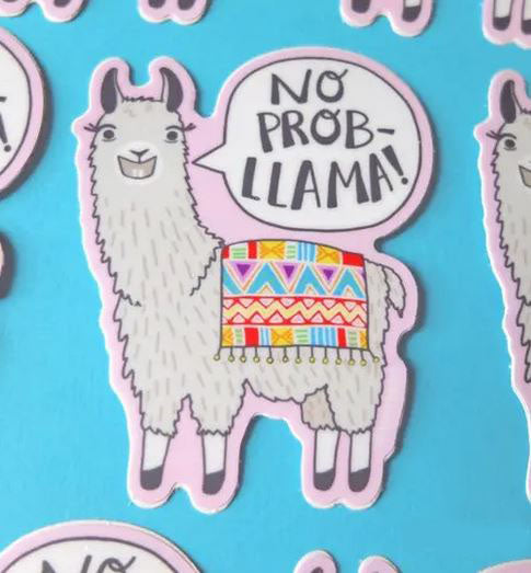 The Lucky Sardine Llama No prob Llama Sticker is a durable, waterproof vinyl featuring a gray llama with a vibrant patterned blanket on its back, smiling against a light blue background. A speech bubble by its head reads "No Prob-llama!" making it perfect for adding some cheer to your laptop or water bottle.